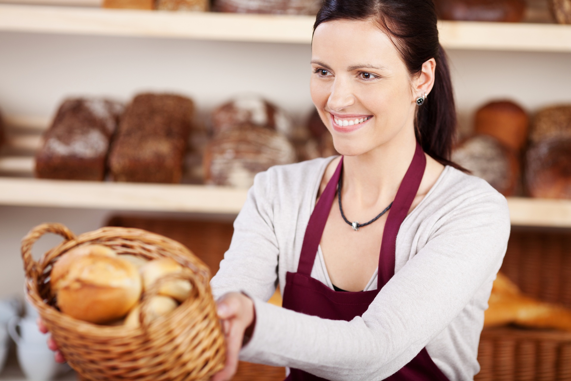 Woman,Working,In,A,Bakery,Offering,A,Customer,A,Basket